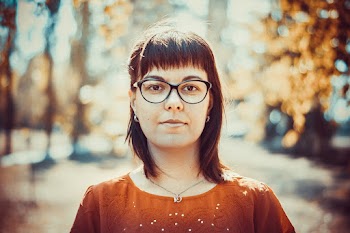 Woman Black Framed Eyeglasses and Orange Crew-neck Top