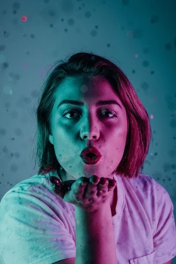 woman blowing a flying kiss
