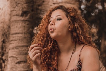 Woman Blowing Dandelion