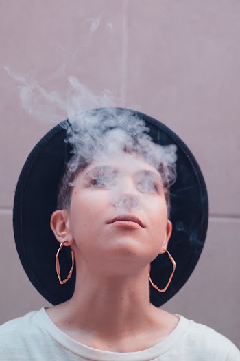 Woman Blowing Off Smoke