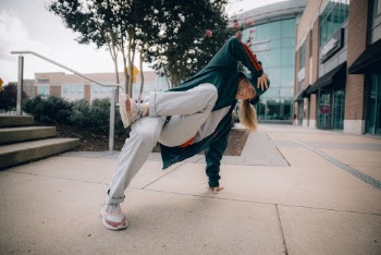 Woman Break-dancing on Concrete Pavement