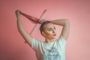 Woman Bunching  Her Long Hair While Looking Up