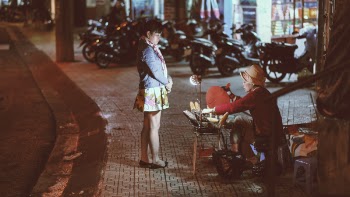 Woman buying from a street vendor