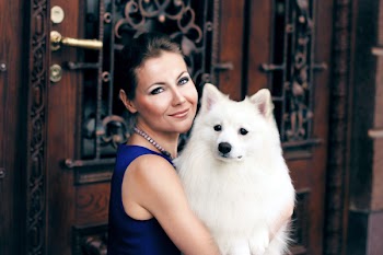 Woman Carrying Adult White Indian Spitz