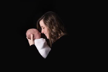 Woman Carrying Baby While Smiling
