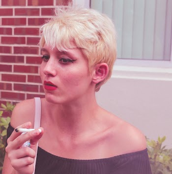 Woman Carrying Bag While Holding Cigarette Stick