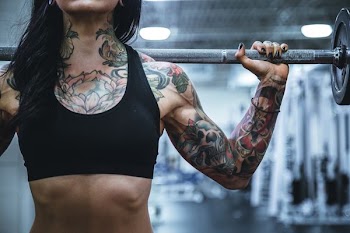 woman carrying barbell