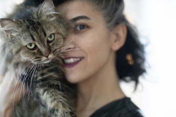 Woman Carrying Brown Tabby Cat