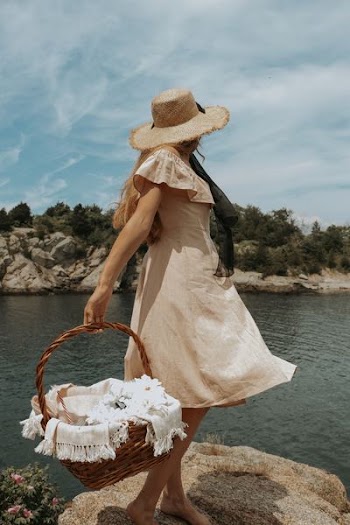 woman carrying brown wicker basket