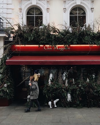 Woman Carrying Child Near Clos Maggiore Stall