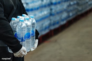 Woman carrying drinking waters with gloved hands during coronavirus pa.. | Free  photo - 2296822