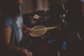 woman carrying drums sticks