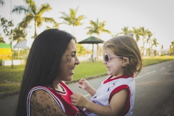 Woman Carrying Girl Outdoors