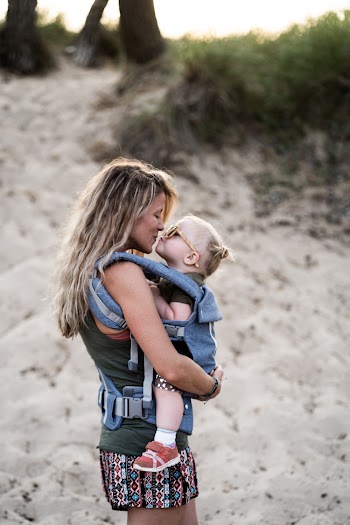 Woman Carrying Girl While Kissing