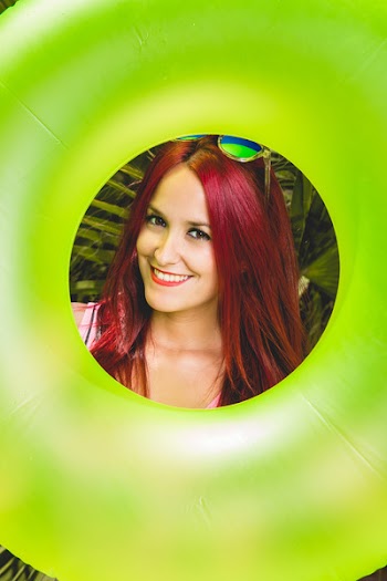 Woman Carrying Green Inflatable Tube