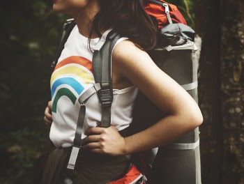 Woman Carrying Hiking Backpack Standing Under Shade of Tree
