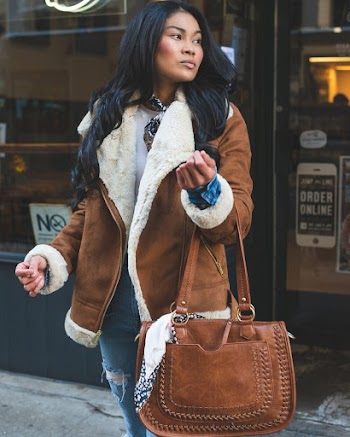 Woman Carrying Leather Handbag and Wearing Brown Coat