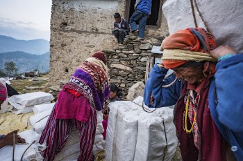 Woman carrying Lokta bark paper, | Free Photo - rawpixel