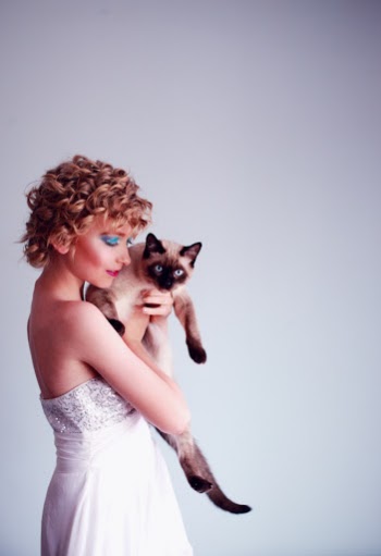 Woman Carrying Siamese Cat