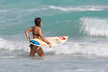 Woman Carrying Surfboard 