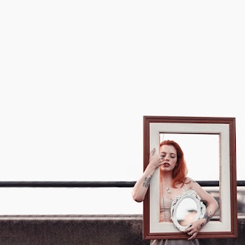 Woman Carrying White and Brown Decorative Frame