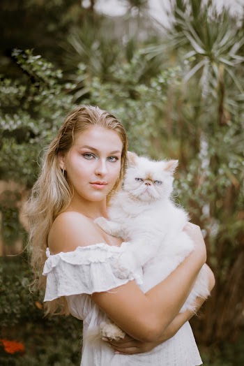 Woman Carrying White Cat