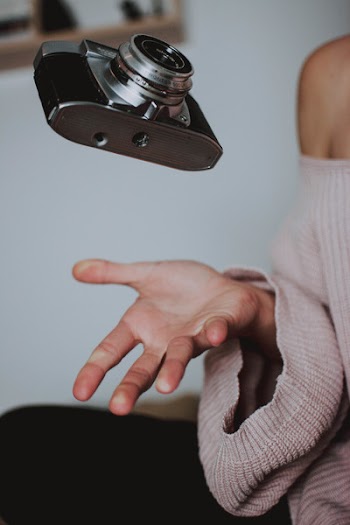 Woman Catching The Camera On Her Palm