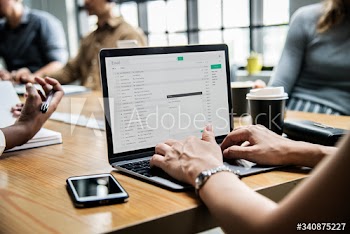 Woman checking her email in a meeting