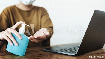 Woman cleaning hands with a hand sanitizer gel to prevent coronavirus contamination