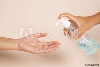 Woman cleaning hands with a hand sanitizer gel to prevent coronavirus contamination