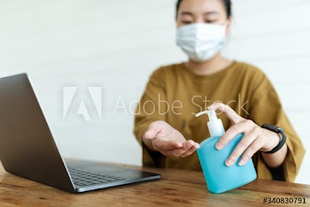 Woman cleaning hands with a hand sanitizer gel to prevent coronavirus contamination