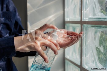 Woman cleaning hands with a hand sanitizer gel to prevent coronavirus contamination