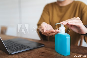 Woman cleaning hands with a hand sanitizer gel to prevent coronavirus contamination