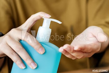 Woman cleaning hands with a hand sanitizer gel to prevent coronavirus contamination