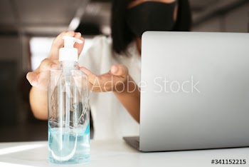 Woman cleaning hands with a hand sanitizer gel to prevent coronavirus contamination