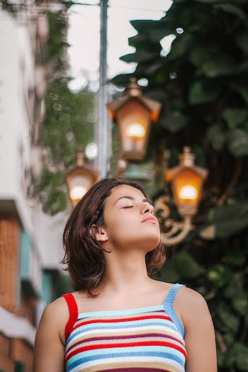 Woman Closing Eyes While Looking Up