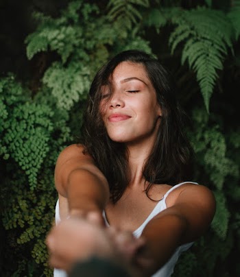 Woman Closing Her Eyes While Holding Another Person's Hand