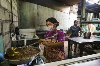 Woman cooking in local kitchen, | Free Photo - rawpixel