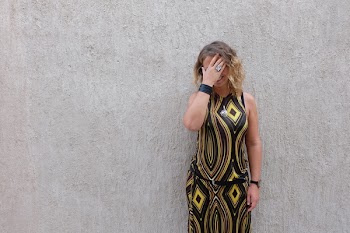 Woman Covering Face Beside Wall