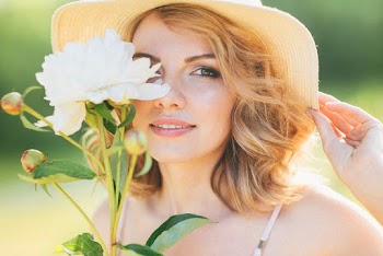 Woman Covering Face With A Flower