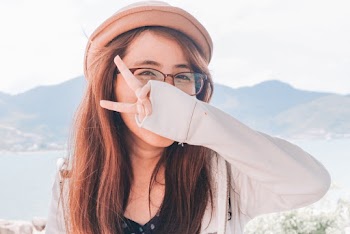 Woman Covering Face With Hand Peace Sign