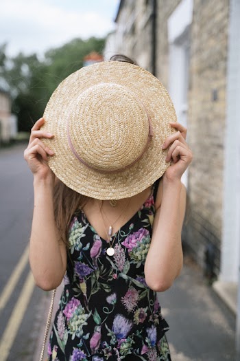 Woman Covering Face With Sunhat