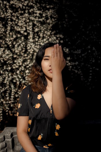 Woman Covering Half of Her Face With Her Left Hand