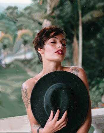 Woman Covering Her Body With Black Cowboy Hat