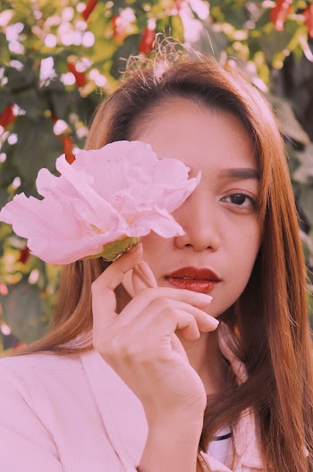 Woman Covering Her Eye with a Flower