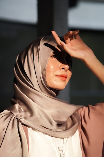 Woman Covering Her Eyes Against Sunlight