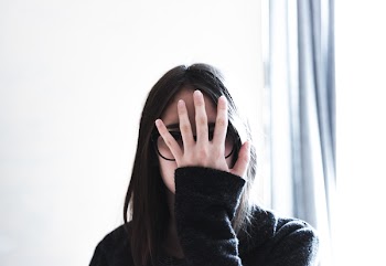 Woman Covering Her Face