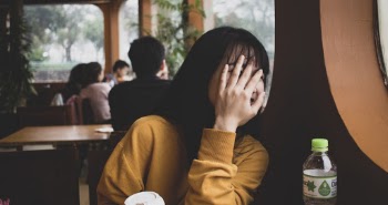 Woman Covering Her Face