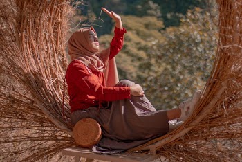 Woman Covering Her Face From Glare Of The Sun
