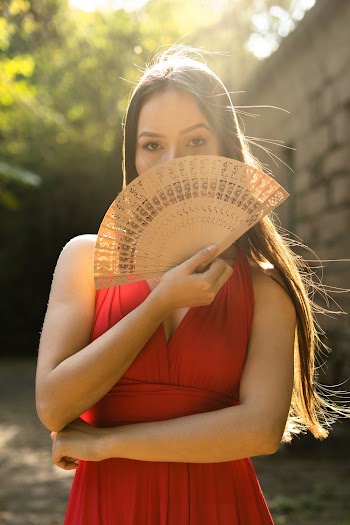 Woman Covering Her Face With a Fan